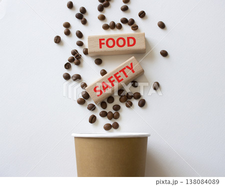 Food Safety symbol. Concept words Food Safety on beautiful wooden picture frame. Beautiful white background with coffee cup and coffee beans. Business and Food Safety concept. Copy space. Food Safety symbol. Concept words Food Safety on beautiful wooden picture frame. Beautiful white background with coffee cup and coffee beans. Business and Food Safety concept. Copy space. 138084089