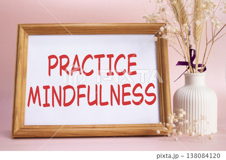 Mindfulness symbol. Concept words Practice Mindfulness on beautiful wooden picture frame. Beautiful pink background with flower vase. Medical and Psychology concept. Copy space. 138084120