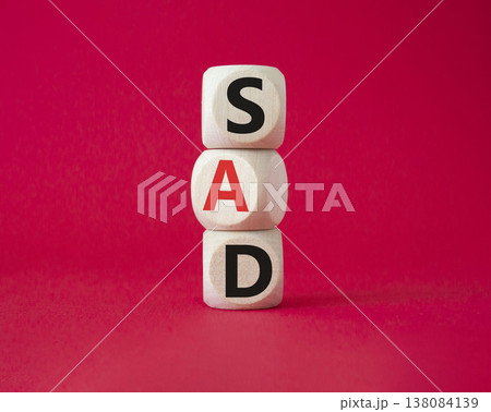 Sad symbol. Wooden cubes with words Sad. Beautiful red background. Business and Sad concept. Copy space. Sad symbol. Wooden cubes with words Sad. Beautiful red background. Business and Sad concept. Copy space. 138084139