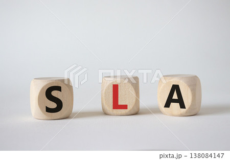 SLA - Service Level Agreement. Wooden cubes with word SLA. Beautiful white background. Business and Service Level Agreement concept. Copy space. 138084147