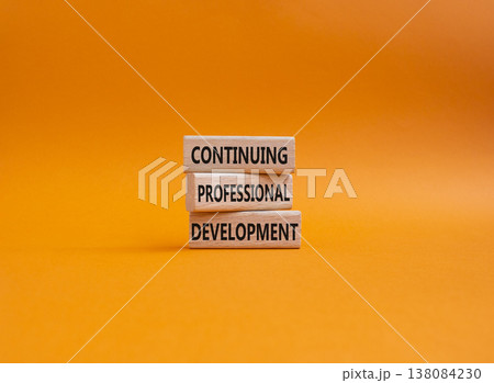 Continuing Development symbol. Concept words Continuing Professional Development on wooden blocks. Beautiful orange background. Business and Development concept. Copy space 138084230