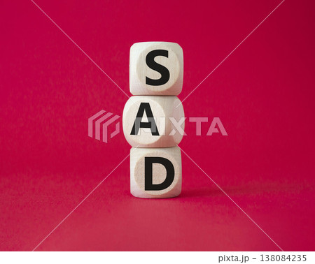 Sad symbol. Wooden cubes with words Sad. Beautiful red background. Business and Sad concept. Copy space. 138084235