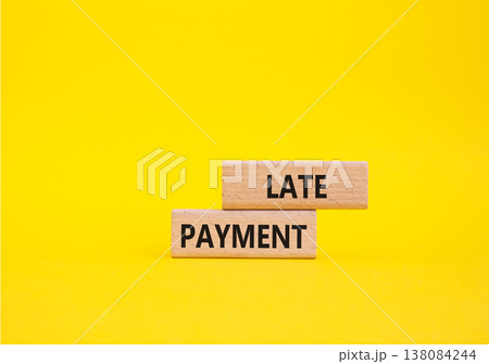 Late payment symbol. Concept word Late payment on wooden blocks. Beautiful yellow background. Business and Late payment concept. Copy space Late payment symbol. Concept word Late payment on wooden blocks. Beautiful yellow background. Business and Late payment concept. Copy space 138084244