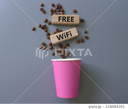 Fee Wifi symbol. Concept words Fee Wifi on beautiful wooden picture frame. Beautiful grey background with coffee cup and coffee beans. Business and Fee Wifi concept. Copy space. Fee Wifi symbol. Concept words Fee Wifi on beautiful wooden picture frame. Beautiful grey background with coffee cup and coffee beans. Business and Fee Wifi concept. Copy space. 138084261