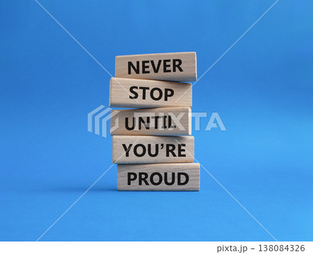 Never Stop symbol. Wooden blocks with words Never Stop Until You are Proud. Beautiful blue background. Business and Never Stop concept. Copy space Never Stop symbol. Wooden blocks with words Never Stop Until You are Proud. Beautiful blue background. Business and Never Stop concept. Copy space 138084326