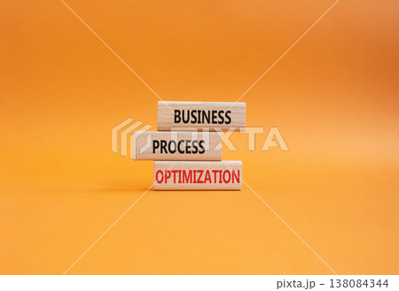 Business Process Optimization symbol. Concept word Business Process Optimization on wooden blocks. Beautiful orange background. Business and Business Process Optimization. Copy space 138084344