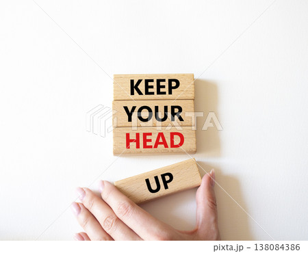 Keep Your Head Up symbol. Concept words Keep Your Head Up on wooden blocks. Beautiful bright white background. Businessman hand. Business and Keep Your Head Up concept. Copy space. 138084386
