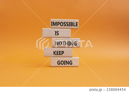 Keep Going symbol. Wooden blocks with words Impossible is Nothing Keep Going. Beautiful orange background. Business and Keep Going concept. Copy space Keep Going symbol. Wooden blocks with words Impossible is Nothing Keep Going. Beautiful orange background. Business and Keep Going concept. Copy space 138084454
