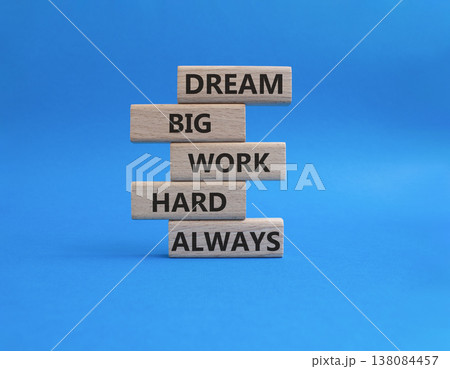 DREAM BIG WORK HARD symbol. Wooden blocks with words DREAM BIG WORK HARD ALWAYS. Beautiful blue background. Businessman hand. Business and DREAM BIG WORK HARD concept. Copy space DREAM BIG WORK HARD symbol. Wooden blocks with words DREAM BIG WORK HARD ALWAYS. Beautiful blue background. Businessman hand. Business and DREAM BIG WORK HARD concept. Copy space 138084457