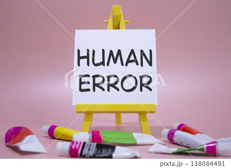 Human Error symbol. Concept word Human Error on wooden blocks. Beautiful white background with paints and easel. Medicine and Human Error concept. Copy space 138084491