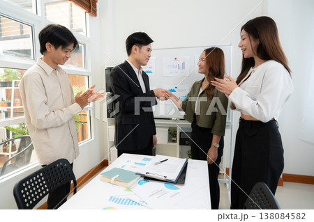 Asian business team handshake for success agreement after marketing presentation. 138084582