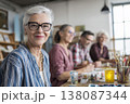 attractive senior woman attending creative workshop with group, painting or crafting together, 138087344