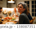 beautiful middle-aged woman in her 30s enjoying dinner with friends at home, modern bright kitchen, 138087351