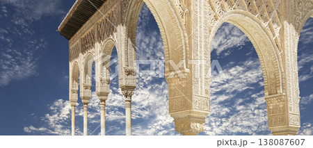 Arches in Islamic (Moorish) style (against the background of a beautiful sky with clouds) in Alhambra, Granada, Spain 138087607