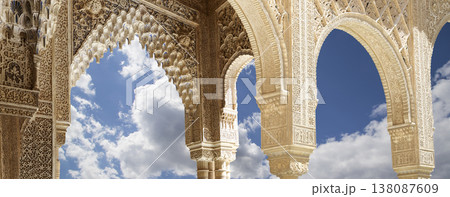Arches in Islamic (Moorish) style (against the background of a beautiful sky with clouds) in Alhambra, Granada, Spain 138087609