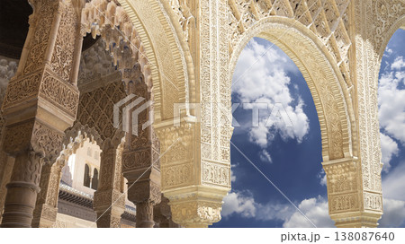 Arches in Islamic (Moorish) style (against the background of a beautiful sky with clouds) in Alhambra, Granada, Spain Arches in Islamic (Moorish) style (against the background of a beautiful sky with clouds) in Alhambra, Granada, Spain 138087640