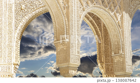 Arches in Islamic (Moorish) style (against the background of a beautiful sky with clouds) in Alhambra, Granada, Spain 138087642