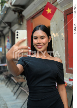 Thai Woman Taking Selfie at Hanoi Train Street in Vietnam Thai Woman Taking Selfie at Hanoi Train Street in Vietnam 138087882