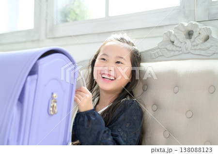 ソファでランドセルを持って嬉しそうな日本人の女の子 ソファでランドセルを持って嬉しそうな日本人の女の子 138088123