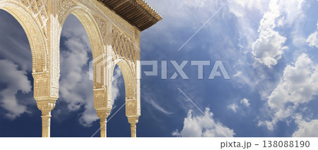 Arches in Islamic (Moorish) style (against the background of a beautiful sky with clouds) in Alhambra, Granada, Spain Arches in Islamic (Moorish) style (against the background of a beautiful sky with clouds) in Alhambra, Granada, Spain 138088190