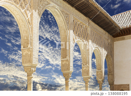 Arches in Islamic (Moorish) style (against the background of a beautiful sky with clouds) in Alhambra, Granada, Spain Arches in Islamic (Moorish) style (against the background of a beautiful sky with clouds) in Alhambra, Granada, Spain 138088195