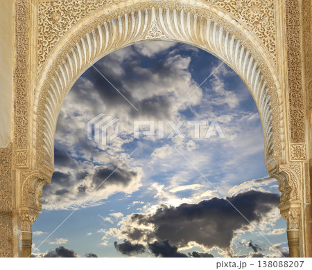 Arches in Islamic (Moorish) style (against the background of a beautiful sky with clouds) in Alhambra, Granada, Spain 138088207
