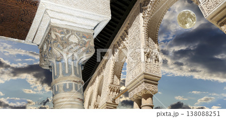 Arches in Islamic (Moorish) style (against the background of a beautiful evening sky with clouds with the super moon) in Alhambra, Granada, Spain Arches in Islamic (Moorish) style (against the background of a beautiful evening sky with clouds with the super moon) in Alhambra, Granada, Spain 138088251