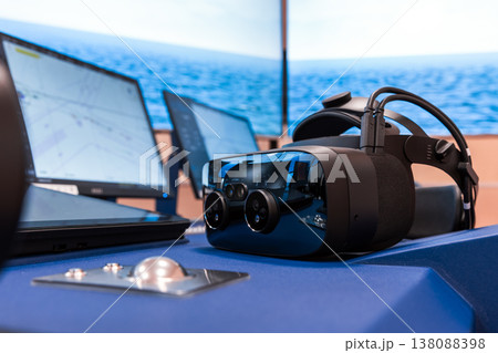 Virtual reality headset sits on a ship bridge console 138088398