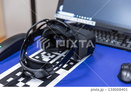 A virtual reality headset rests on an AR tracking marker 138088401