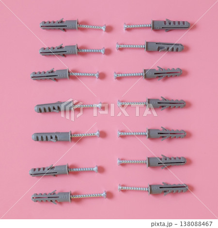 Plastic anchor bolts are attached equipment on the wall. 138088467