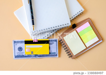 Credit card clip on dollar bills with book note . Credit card clip on dollar bills with book note . 138088497