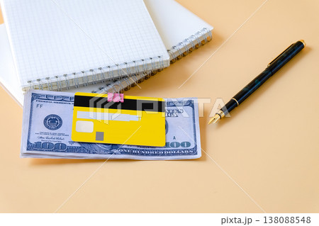 Credit card clip on dollar bills with book note . 138088548