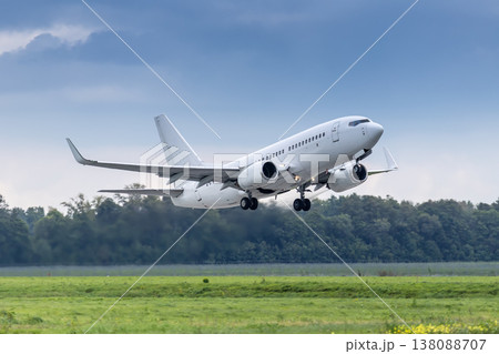 Modern white passenger jetliner takes off runway in cloudy weather 138088707