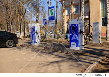 Electric car vehicle charging stations and a power transformer at a public parking lot 138088721