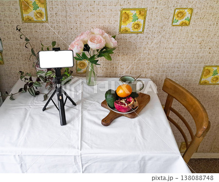 Content creation setup with smartphone, flowers, and fruits, lifestyle photography scene Content creation setup with smartphone, flowers, and fruits, lifestyle photography scene 138088748