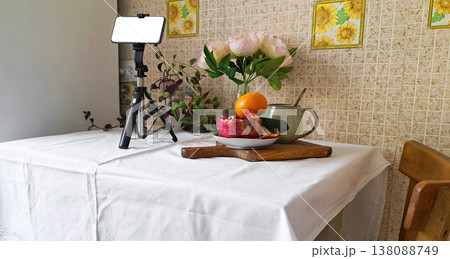 Content creation setup with smartphone, flowers, and fruits, lifestyle photography scene 138088749