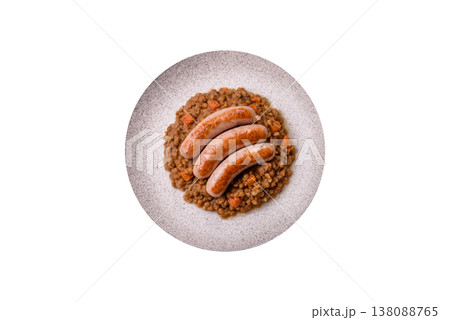 Lentil, carrot, and tomato stew with sausages, a European dish. Lentils with sausages 138088765