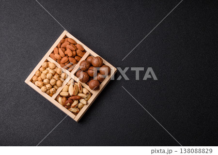 Wooden box with macadamia nuts, almonds, pistachios, and hazelnuts. Nuts as a food background 138088829