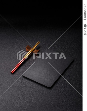 An empty slate cutting board with cutlery on a kitchen counter. Slate cutting board 138088872