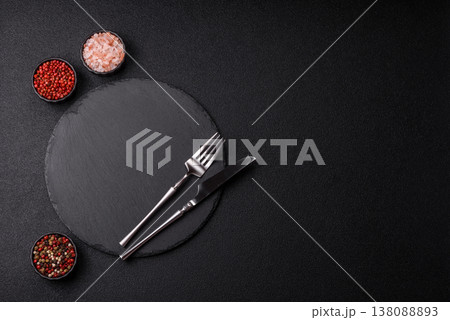 An empty slate cutting board with cutlery on a kitchen counter. Slate cutting board An empty slate cutting board with cutlery on a kitchen counter. Slate cutting board 138088893