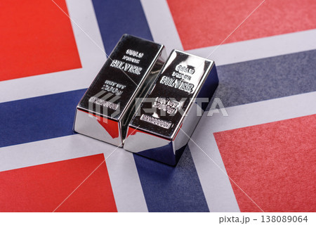 A silver bar against a backdrop of Norway flag, as a concept for the sales market. A silver bar 138089064