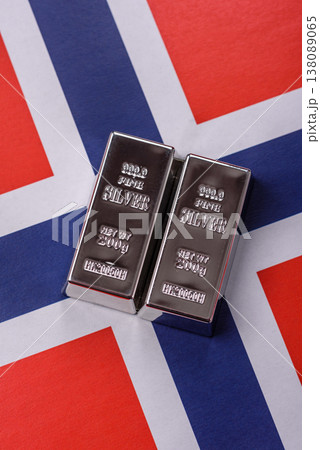 A silver bar against a backdrop of Norway flag, as a concept for the sales market. A silver bar 138089065