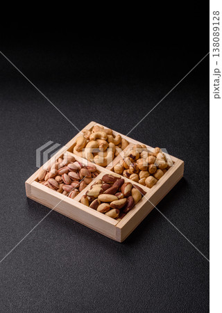 A box of cashews, hazelnuts, pistachios, and Brazil nuts as healthy food ingredients. A box of nuts 138089128