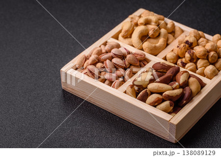 A box of cashews, hazelnuts, pistachios, and Brazil nuts as healthy food ingredients. A box of nuts A box of cashews, hazelnuts, pistachios, and Brazil nuts as healthy food ingredients. A box of nuts 138089129