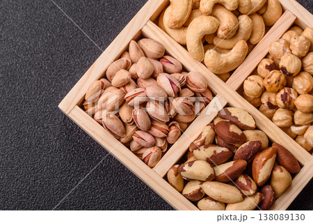 A box of cashews, hazelnuts, pistachios, and Brazil nuts as healthy food ingredients. A box of nuts A box of cashews, hazelnuts, pistachios, and Brazil nuts as healthy food ingredients. A box of nuts 138089130