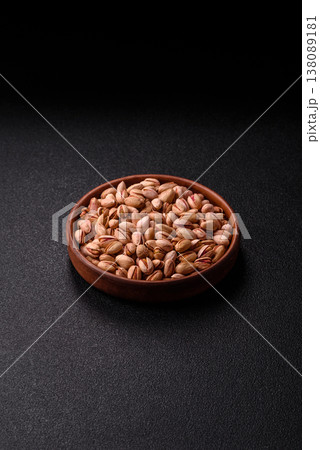 Salted pistachio nuts in shells as a healthy, high calorie food ingredient. Pistachio nuts 138089181