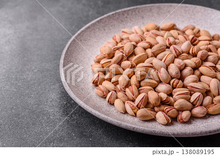 Salted pistachio nuts in shells as a healthy, high calorie food ingredient. Pistachio nuts Salted pistachio nuts in shells as a healthy, high calorie food ingredient. Pistachio nuts 138089195