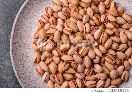 Salted pistachio nuts in shells as a healthy, high calorie food ingredient. Pistachio nuts 138089196