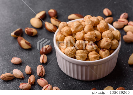 Whole peeled hazelnuts, roasted or raw, as an ingredient for healthy food. Hazelnuts as a background 138089260