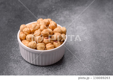 Whole peeled hazelnuts, roasted or raw, as an ingredient for healthy food. Hazelnuts as a background 138089263
